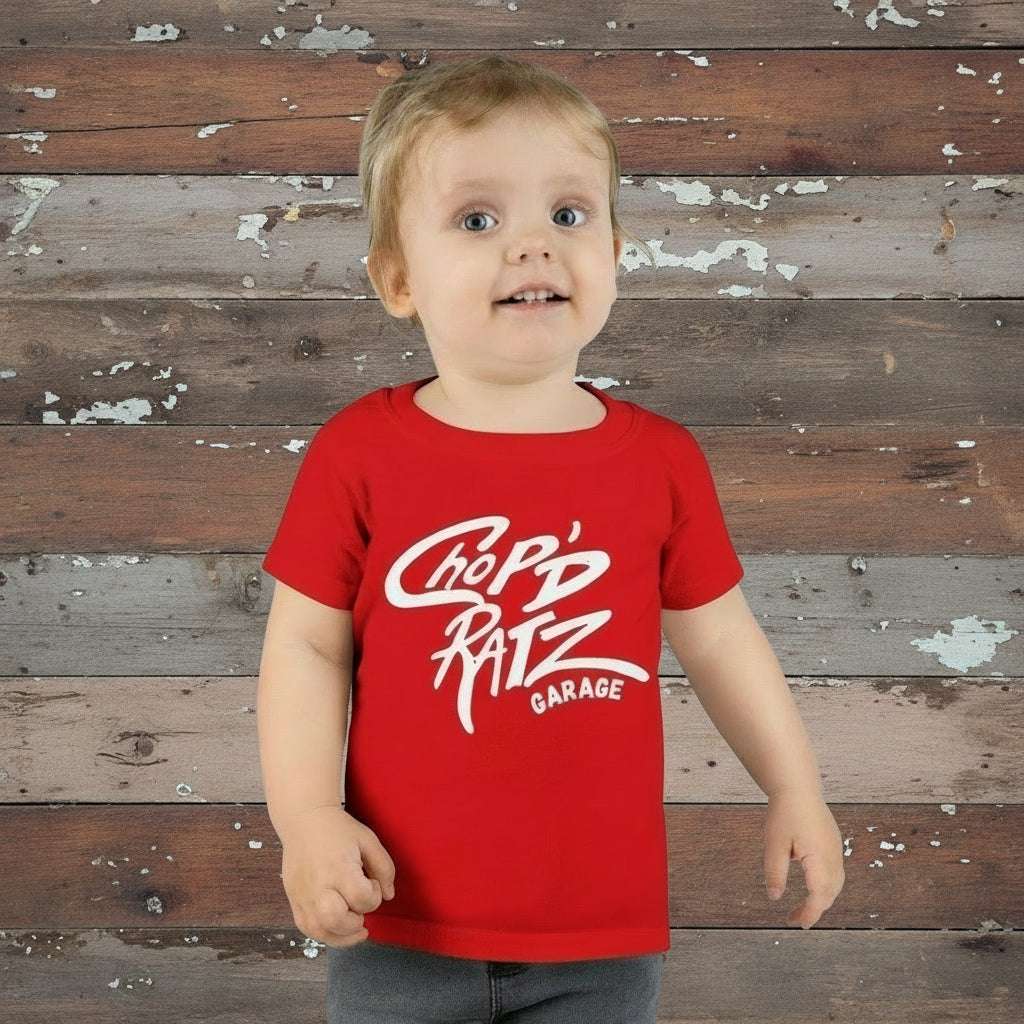 Child wearing a red t-shirt with 'Chop'd Ratz Garage' text