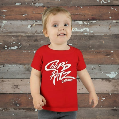 Child wearing a red t-shirt with 'Chop'd Ratz Garage' text